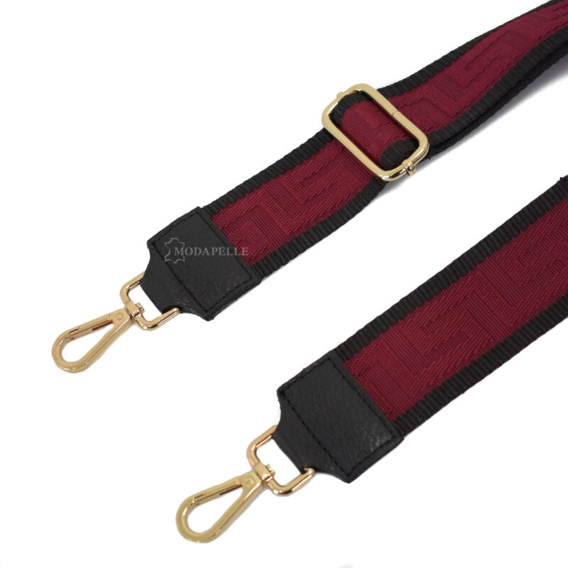 Adjustable bag strap, in red color (meander texture). With gold metallic parts and leather finishes