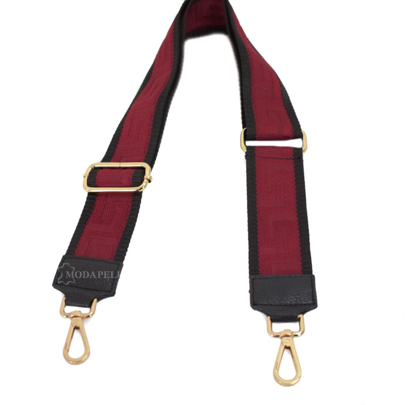 Adjustable bag strap, in red color (meander texture). With gold metallic parts and leather finishes